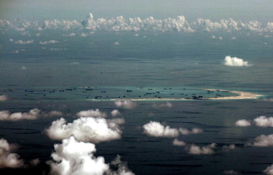 This Monday, May 11, 2015, file photo, taken through a glass window of a military plane, shows China’s alleged on-going reclamation of Mischief Reef in the Spratly Islands in the South China Sea. China’s campaign of island building in the South China Sea might soon quadruple the number of airstrips available to the People’s Liberation Army in the highly contested, environmentally delicate, and strategically vital region. (Ritchie B. Tongo/Pool Photo via AP, File)